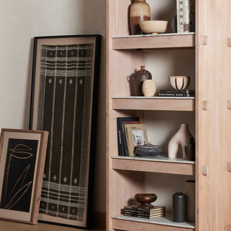 Four Hands Bhujodi Style Textile against wall shown with shelf